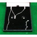 A diamond pendant and earring set