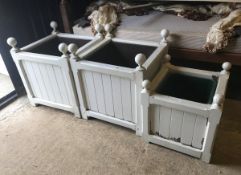 A pair of Stuart Garden Architecture painted wooden square planters in the Versailles manner
