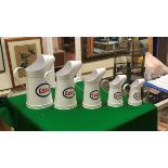 A graduated set of five modern Esso oil cans