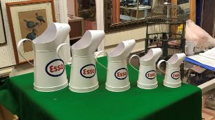 A graduated set of five modern Esso oil cans