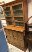 A Victorian pitch pine two door cupboard with chamfered panelled doors together with the associated