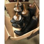 A pair of black leather riding boots with wooden trees,