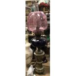 A late Victorian brass oil lamp in the Classical style with blue glass reservoir and cranberry