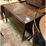 A 19th Century mahogany drop leaf Pembroke table with single drawer on turned tapering legs to