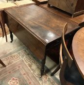 A 19th Century mahogany drop leaf Pembroke table with single drawer on turned tapering legs to