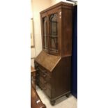 A 19th Century mahogany bureau bookcase with glazed upper section over a sloping fall and two short