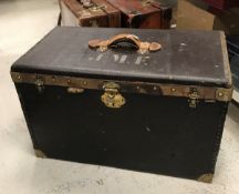 A 19th Century French canvas covered and leather embellished trunk with brass lock plate and clips