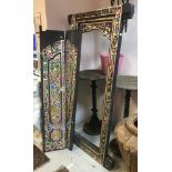 A 20th Century Indian carved and painted teak doorway with a pair of doors and surround and all