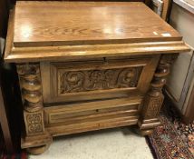 A circa 1900 Continental oak dwarf cupboard with fall-front compartment over a single drawer on