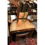 An early 20th Century Arts and Crafts style oak dressing table of small proportions,