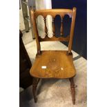 A set of four modern oak stick back kitchen chairs in the Victorian manner