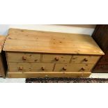 A pine dwarf chest of three short over two long drawers in the Victorian manner