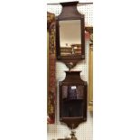 A pair of mahogany framed mirrored wall sconces in the Arts & Crafts style