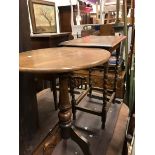 An early 20th Century oak framed footstool together with an oak occasional table and a mahogany