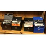 A collection of six singles cases and contents of various 45 rpm single records by Queen, Rainbow,