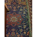 A Caucasian rug with centre medallion on a blue ground with all over scrolling foliate decoration