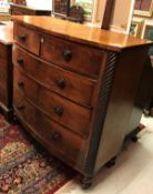A Victorian mahogany bow fronted chest of two short over three long graduated drawers flanked by