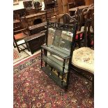 A late Victorian ebonised and gilt decorated over mantle mirror the base set with three painted