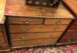 An 18th Century oak chest the plain top with applied edging over two short and three long drawers