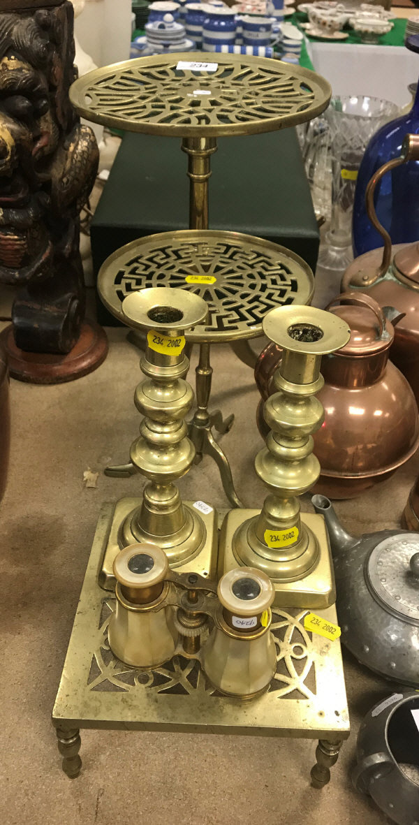 An early 19th Century brass tripod trivet another similar smaller, a square pierced brass trivet,