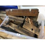 A collection of various vintage woodworking tools including a plough plane, another plane by W.