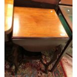An Edwardian mahogany tea table with four shaped drop leaves on cabirole legs united by an under