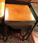 An Edwardian mahogany tea table with four shaped drop leaves on cabirole legs united by an under