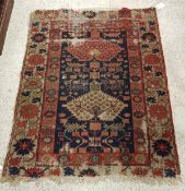 A Persian rug with two stylised lozenge shaped medallions on a foliate decorated blue ground within