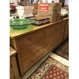 A pair of modern light oak chests of six drawers together with two oak bedside cabinets