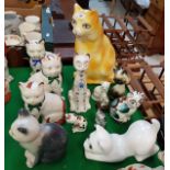 A collection of thirteen various pottery cat ornaments by Plichta,