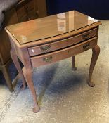 A mid 20th Century mahogany bow fronted two drawer canteen table with baize lined interior on