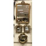 A pair of gilt metal framed Rococo style wall mirrors with scrolling acanthus decoration together