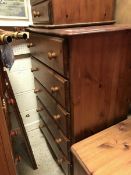 A pair of modern pine chests of five long drawers, together with a matching three-drawer chest,