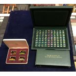 A cased set of "100 Greatest Cars Silver Miniature Collection" by John Pinches with later coloured