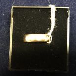 An 18 carat gold band set with three diamonds, approx 6.
