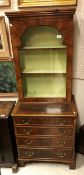 A walnut and inlaid cabinet on chest in the 18th Century style the single glazed door enclosing two