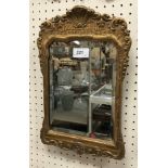 A 19th Century gilt and gesso framed mirror mounted on easel back