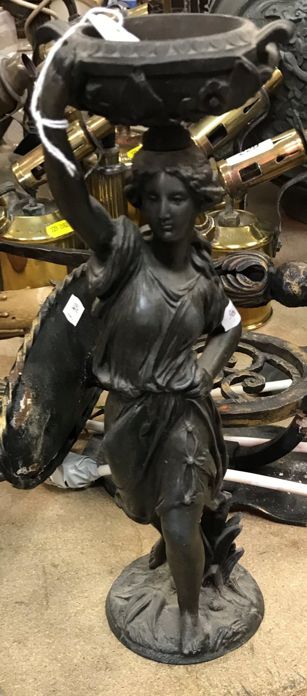 A circa 1900 patinated spelter figure with foliate-decorated urn upon her head in the Classical