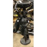 A circa 1900 patinated spelter figure with foliate-decorated urn upon her head in the Classical