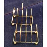 A pair of four section silver toast racks (Birmingham 1925) approximately 3 oz