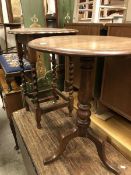 An oak tripod occasional table together with a further oak occasional table and a wrought iron