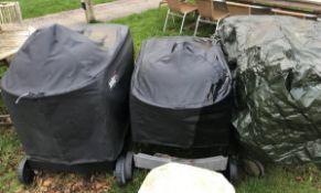 Two Weber barbecues and a teak serving table