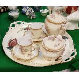 A Limoges rose and gilt decorated tête-à-tête teaset (no jug) on an associated two handled tray