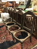 A set of six Continental 19th Century oak dining room chair frames with carved fruit decorated top