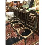 A set of six Continental 19th Century oak dining room chair frames with carved fruit decorated top