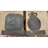 Two cast lead fire marks, one "protector" decorated with firemen and blazing house,