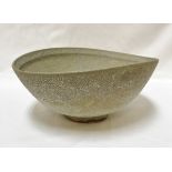 CHRIS CARTER (Born 1945) - a thrown and altered footed bowl with oxidised glaze,