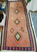 A 20th Century Kelim rug in blue, red, brown and orange,