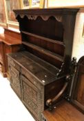 An 18th Century oak dresser (probably Northern European) the two tier boarded plate rack over two