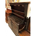 An 18th Century oak dresser (probably Northern European) the two tier boarded plate rack over two